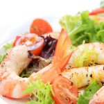 Prawn salad. Simple and healthy salad of shrimp, mixed greens and tomatoes.